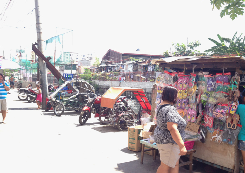 tricycles, pedicabs, and make shift rolling stores parked in the crowded Apelo Cruz Street in Pasay City