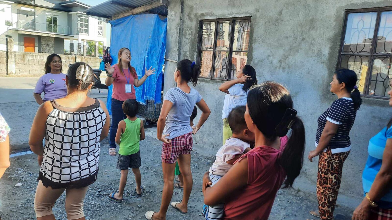 Nurse Angeline demonstrates the Exercise routine to the community members in Barangay Recuerdo, Nampicuan, Tarlac