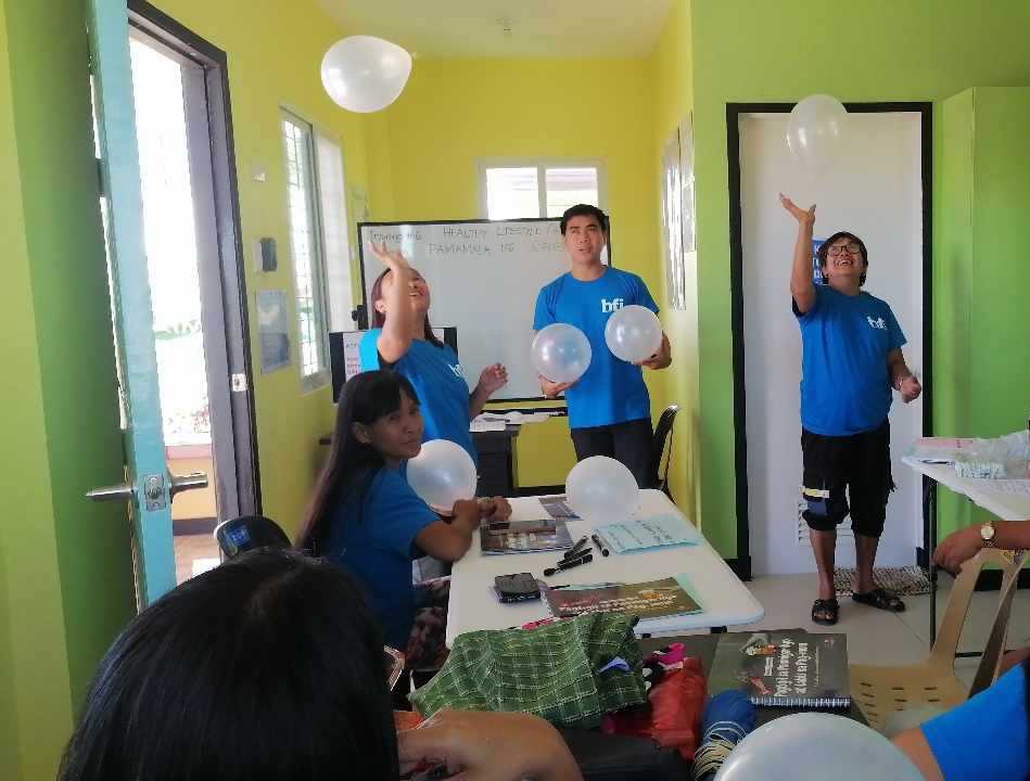 Nurse Cliff facilitates a Balloon Exercise to list and process the stressors identified by the CHWs during the Stress Management Training in Barangay Maasin, Pura, Tarlac