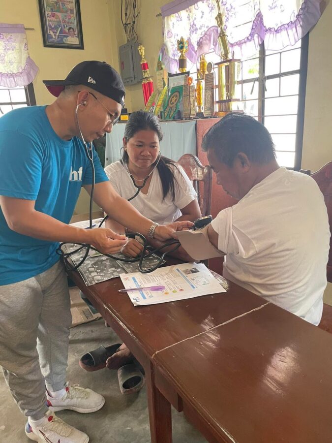 Nurse Dominique demonstrating blood pressure measurement to a CHW during their Vital Signs Training in Barangay San Vicente, San Manuel, Tarlac