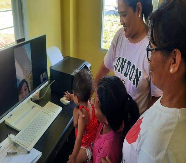Barangay Health Workers (BHWs) assisting in the teleconsultation between a patient at the Recuerdo BHS and Municipal Health Officer (MHO) at the RHU in Nampicuan, Nueva Ecija