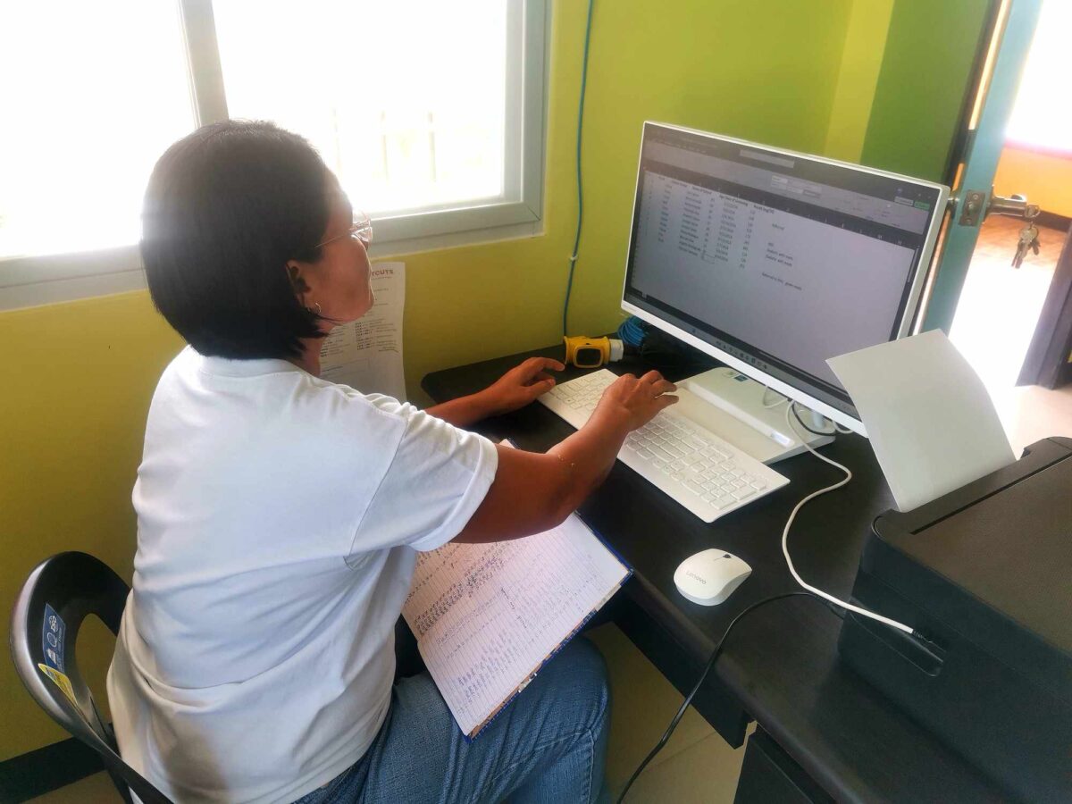 A Barangay Health Worker (BHW) encoding health data in a spreadsheet software in Barangay Maasin, Pura, Tarlac