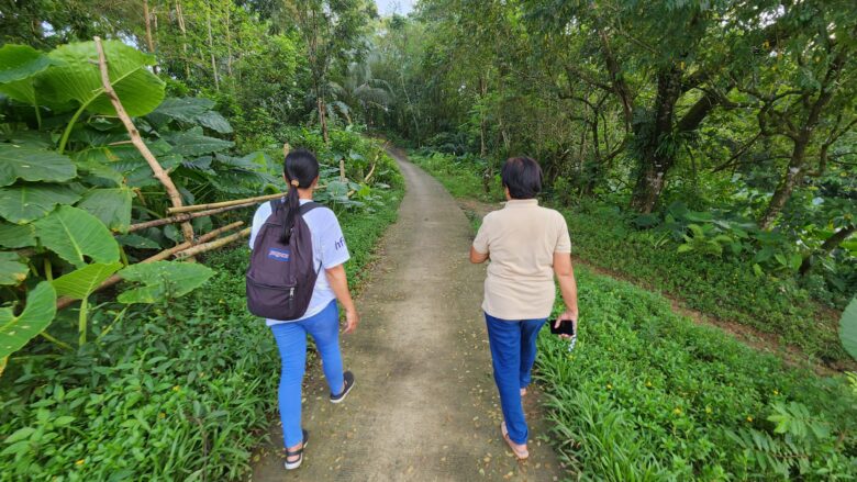 Ms. Joan and the Barangay Nutrition Scholar of Barangay San Dimas are on their way to check a household beneficiary’s garden.