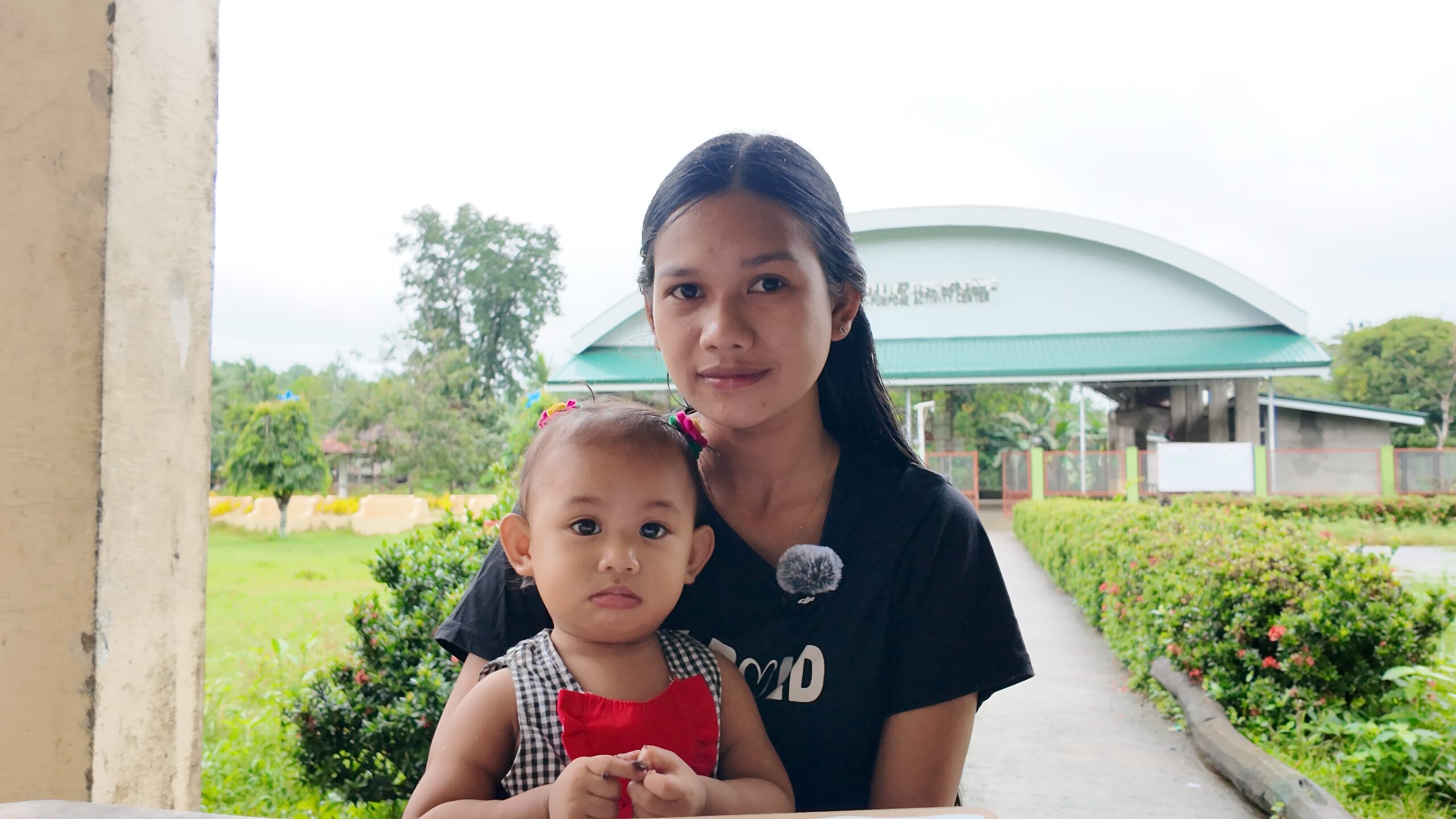 A mother of undernourished children, a beneficiary from Barangay San Roque, receiving support through the Mingo supplementation program