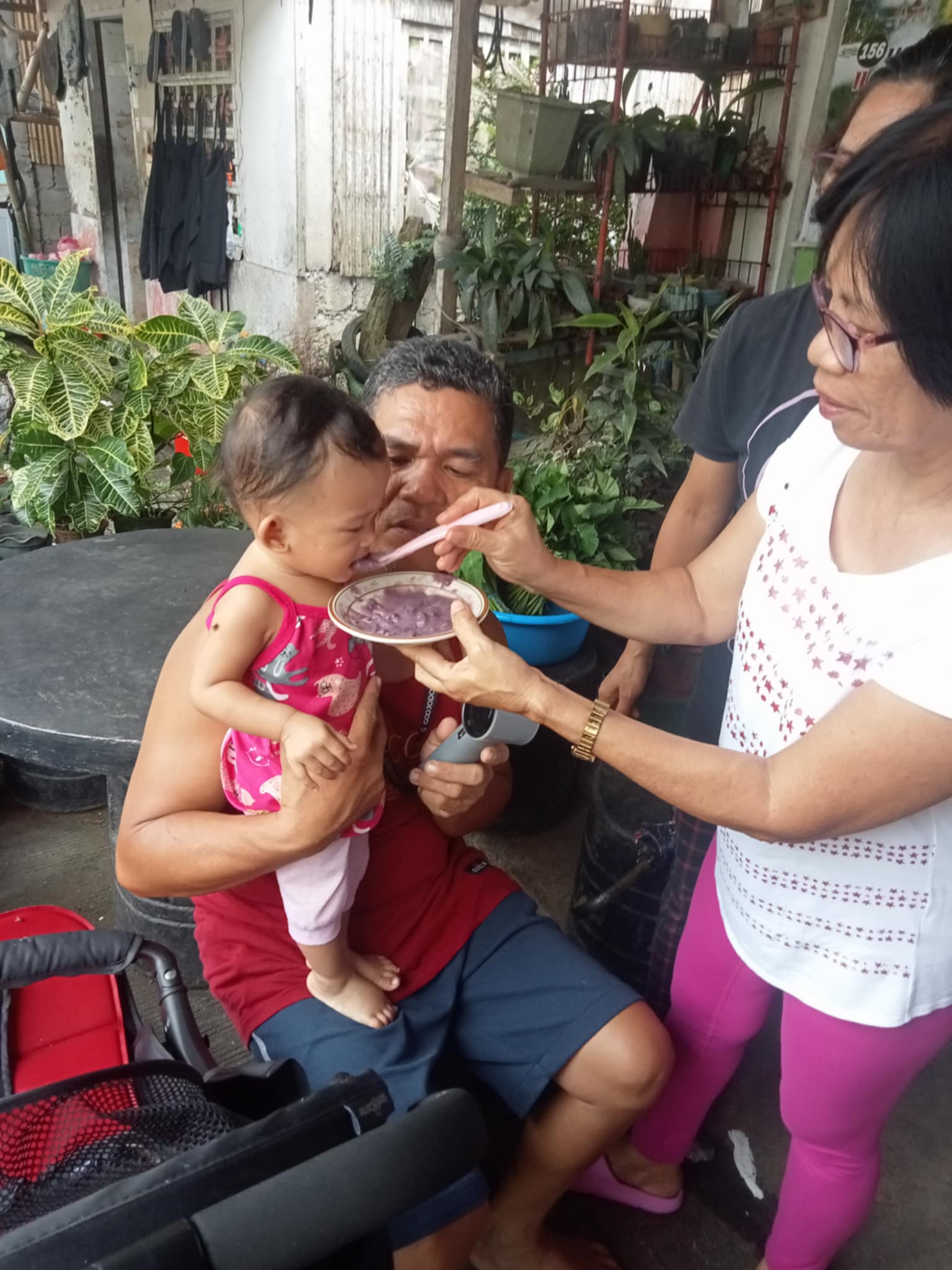 A mother from Barangay Poblacion feeding her child the Mingo meal provided under the supplementation program to support the child’s nutritional needs