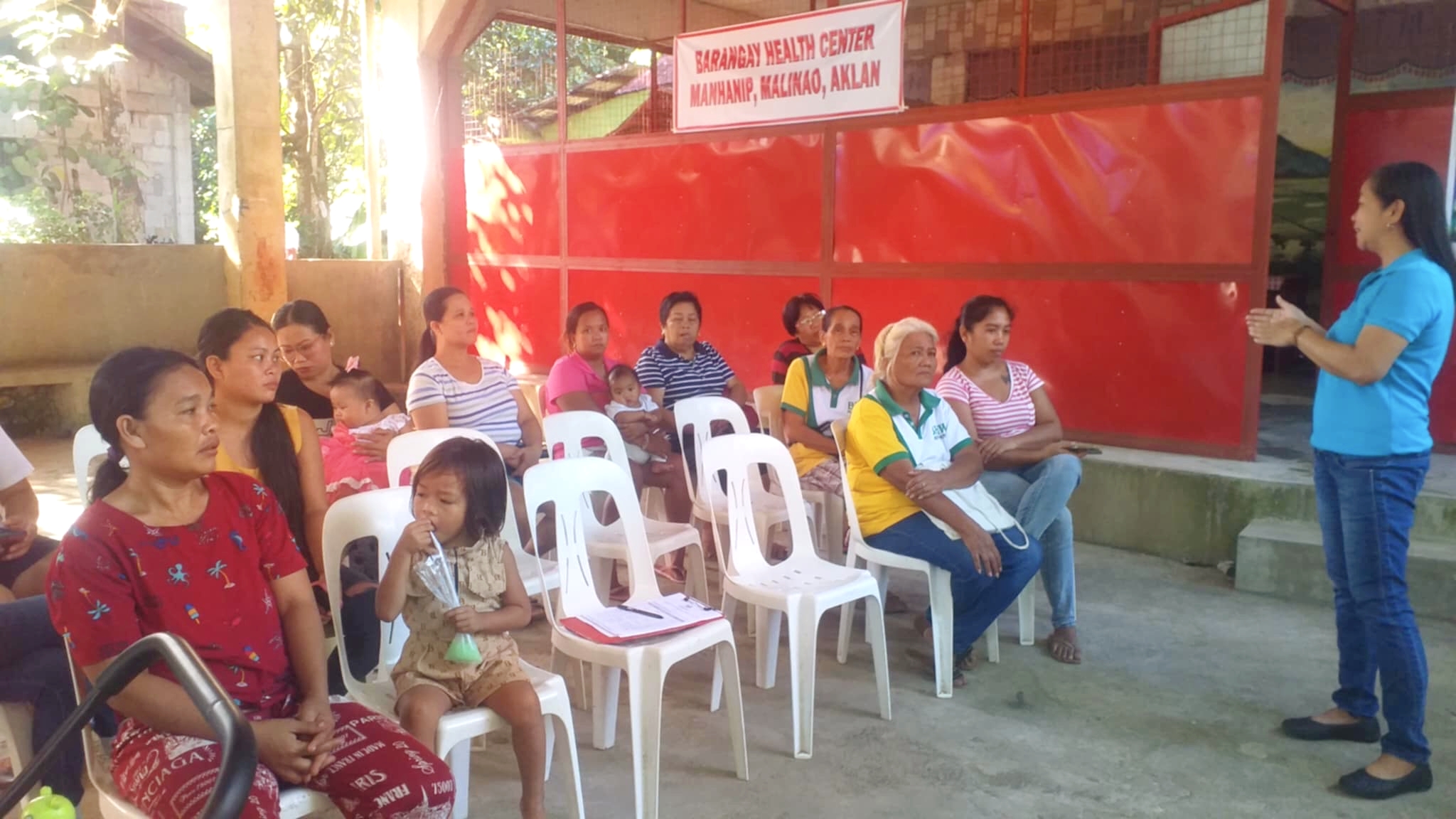 HFI Community Mobilizer training community members on home gardening